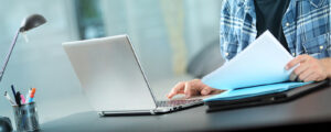1a-COURSES-student-working-online-300x120 Happy Self Employed Man Working Online At Home On A Laptop
